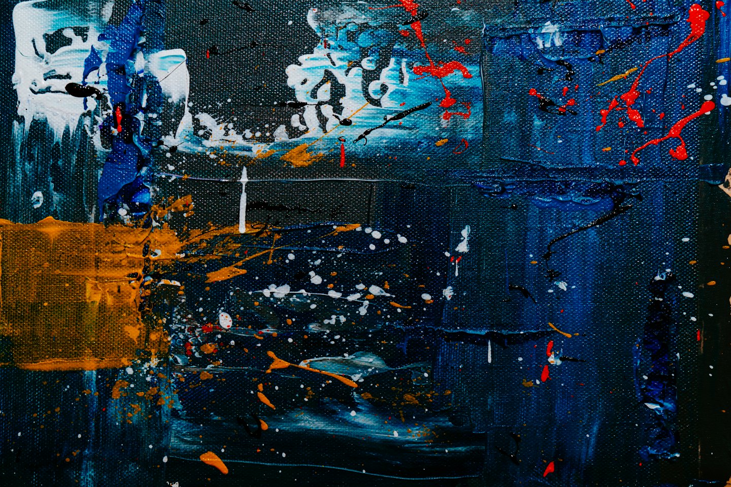Pittura astratta con striature blu scuro e schizzi di vernice arancione.